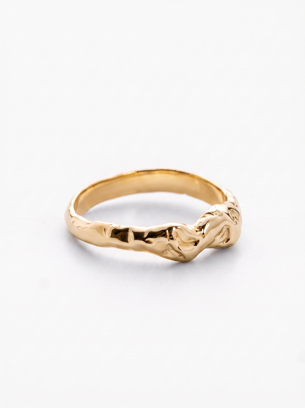 A gold ring with a textured, organic, knot-like design on a clean white background.